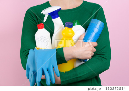 woman with many cleaning products in her arms woman with many cleaning products in her arms 110872814
