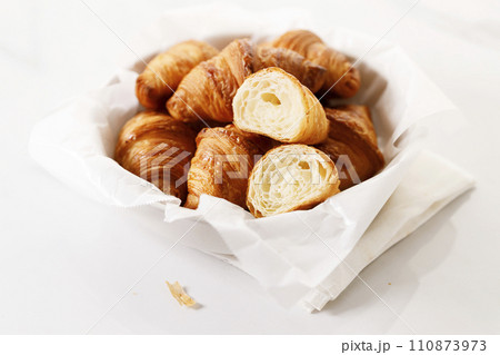 Fresh baked croissants on white table. 110873973