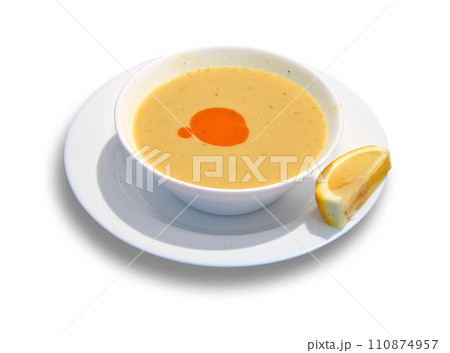 Tasty lentil bowl on plate with lemon isolated on white Tasty lentil bowl on plate with lemon isolated on white 110874957