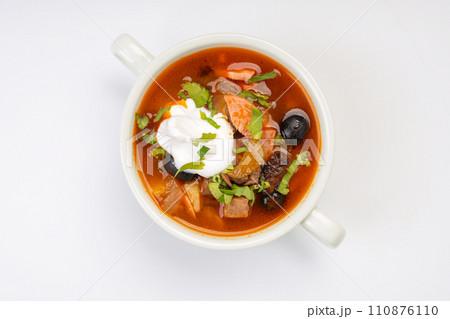 Traditional Russian soup solyanka in a white bowl on a white background 110876110