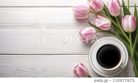 Cup of tea or coffee and tulips on wooden table top view with copy space 110877673