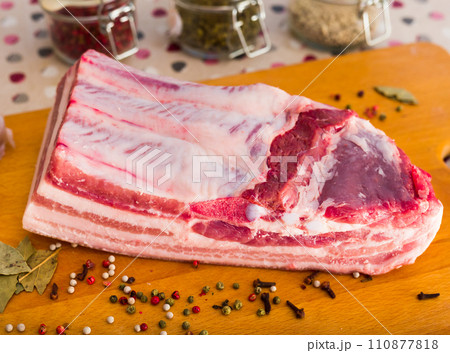 Cooking traditional homemade lard with spices. pork belly with layer on board 110877818