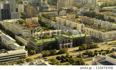 Aerial view of large russian city, buildings, trees and modern glass skyscraper in summer in warm sunny day. Stock footage. Beautiful urban landscape Aerial view of large russian city, buildings, trees and modern glass skyscraper in summer in warm sunny day. Stock footage. Beautiful urban landscape 110878306