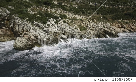 The waves breaking on a stony beach, forming a spray. Footage. Splashing waves on the rocks of the sea 110878507