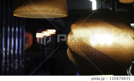 Warm lighting coming out from beautiful lamps while taking a hot cup of coffee in a trendy cafe with nice environment 110878635