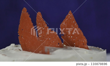 Red decorative element on the cake. Marmalade on the cake. Slice of strawberry cake 110878696