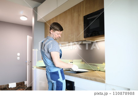 Man electrical repairs kitchen surface apartment Man electrical repairs kitchen surface apartment 110878988