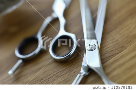 Close-up, steel barber scissors are lying on table 110879182