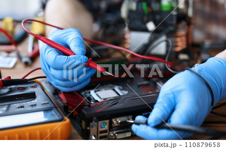 Gloved hands, on table repair an electronic device Gloved hands, on table repair an electronic device 110879658