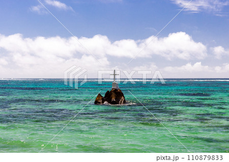 White cross mounted on a coastal rock on a sunny day, Anse Royale, Seychelles White cross mounted on a coastal rock on a sunny day, Anse Royale, Seychelles 110879833