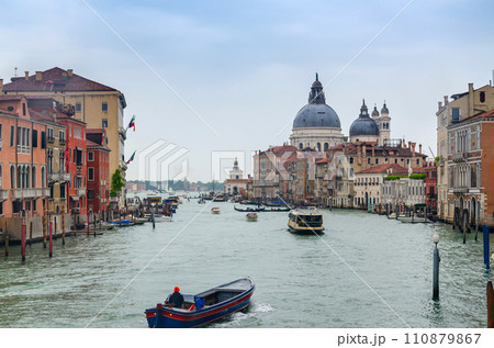 Grand canal in Venice, Italy, with devin Santa Maria della Salute church domintaing in the cityscape 110879867
