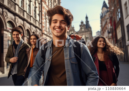 Happy multiracial friends walking down the street. Friendship concept with multicultural young people on winter clothes having fun together Happy multiracial friends walking down the street. Friendship concept with multicultural young people on winter clothes having fun together 110880664