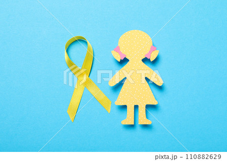 A paper figure of a girl with a yellow ribbon 110882629