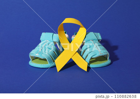Blue children's shoes with a yellow ribbon Blue children's shoes with a yellow ribbon 110882638
