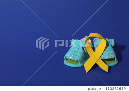 Blue children's shoes with a yellow ribbon Blue children's shoes with a yellow ribbon 110882639