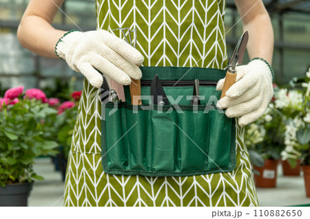Tools for plant care, for watering, trimming, fluffing. On the waist cover. Tools for plant care, for watering, trimming, fluffing. On the waist cover. 110882650