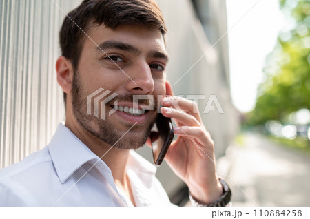 Young elegant man with a phone in hands 110884258