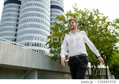 Young dark-haired man in white shirt smiling and feeling joyful Young dark-haired man in white shirt smiling and feeling joyful 110884318
