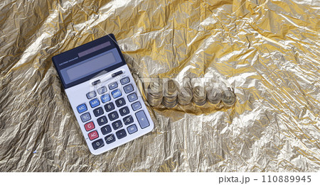 Calculator and 10 ruble Iron coins (written ten rubles, the Bank of Russia). Finance and business concept Calculator and 10 ruble Iron coins (written ten rubles, the Bank of Russia). Finance and business concept 110889945