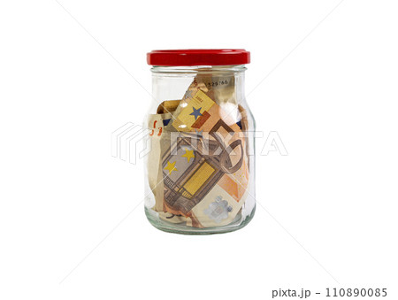 EURO bills in a glass jar, on a white background 110890085
