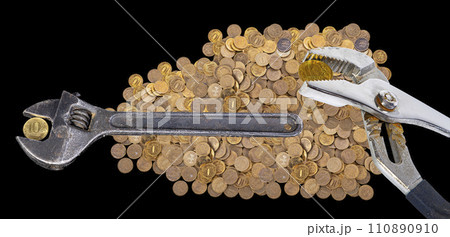 Allegory of the global financial crisis - Iron 10 rubles coin (written ten rubles, Bank of Russia in the Russian) in the grip of economic crisis, on a black background. Finance and business concept 110890910