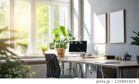 Blank poster frame mock up template above table in office room interior in modern style, white walls, PC and many plants. Play of light and shadows 110891924