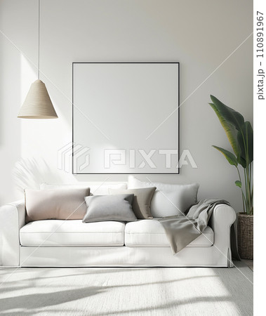 Blank poster with black thin frame mock up template, living room interior in fusion style with white sofa, carpet, white walls and plants. Play of light and shadow 110891967