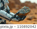 humanoid robot exploring a mineral sample on the planet Mars 110892042