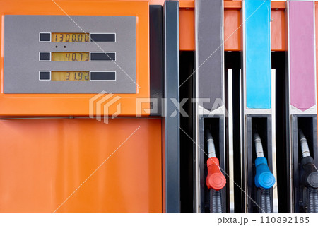 Closeup background image of nozzles in row on orange fuel pump in modern gas station 110892185
