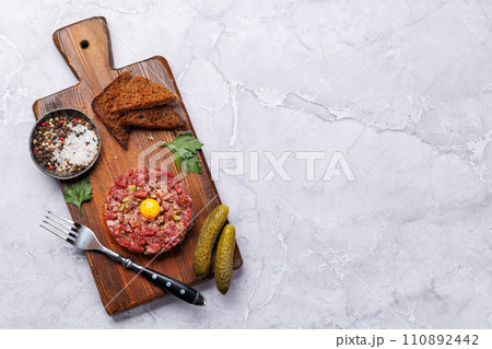 Savory beef tartare and brown bread toasts Savory beef tartare and brown bread toasts 110892442