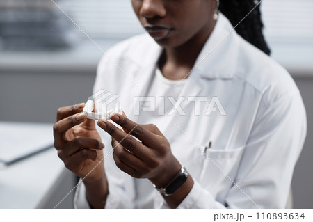Cropped shot of African American female laboratory engineer holding printed 3D dental model 110893634
