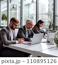 Businesspeople working on a laptops in an office with white walls, wide windows, dressed according to the business dress code and focused on work 110895126