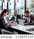 Businesspeople working on a laptops in an office with white walls, wide windows, dressed according to the business dress code and focused on work 110895128