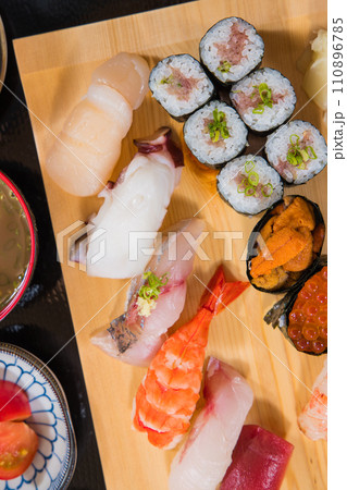 bird view Seafood sushi and sashimi on a wooden cutting board closeup 110896785