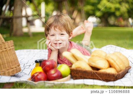 Happy family picnic in the park public on summer holiday. Family boy relax and enjoying outdoor. Happy family picnic in the park public on summer holiday. Family boy relax and enjoying outdoor. 110896888