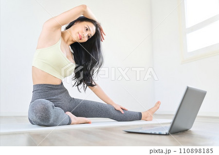 動画を見ながらストレッチをする女性 動画を見ながらストレッチをする女性 110898185