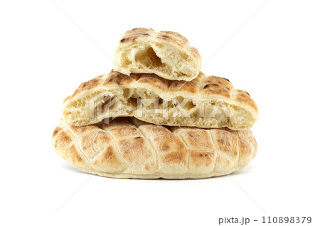 Pita flat-bread toasted of a grid pattern over white 110898379