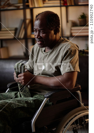 Senior traumatized african american veteran in wheelchair speaking at individual therapy session Senior traumatized african american veteran in wheelchair speaking at individual therapy session 110902740