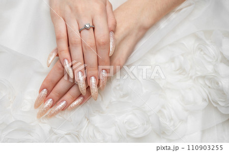 Hand of a young woman with white pearl  manicure 110903255