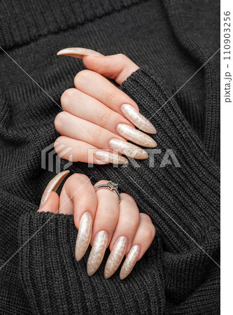 Hand of a young woman with white pearl  manicure 110903256