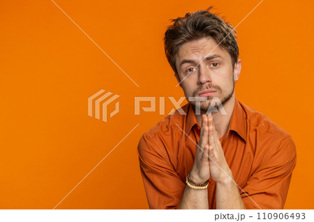 Caucasian sad man praying making wish, asking hopeful help, begging apology, meditation, imploring 110906493
