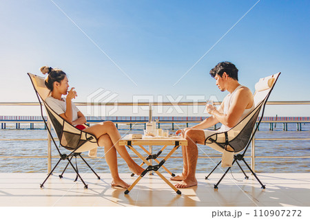 Asian couple lover enjoy their holiday at the sea in the summer with beautiful clear sky ocean view. 110907272