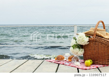 The concept of a picnic by the sea, with flowers. 110907517