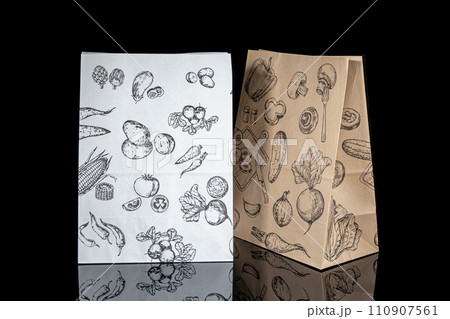 Recyclable craft paper bag for purchases, gifts and takeaway food mock up on black background. Environmentally friendly than single-use plastic bags Recyclable craft paper bag for purchases, gifts and takeaway food mock up on black background. Environmentally friendly than single-use plastic bags 110907561