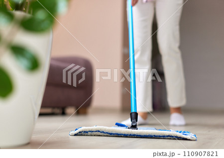 young woman cleaning and mopping floor at living room, daily housekeeping , close-up 110907821