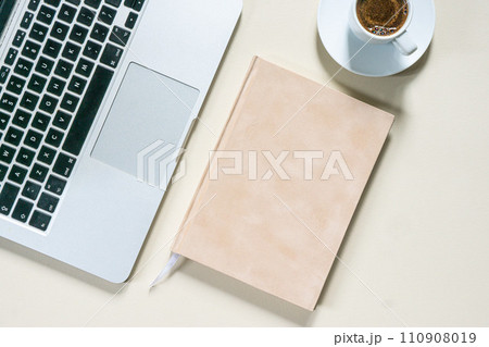 bright feminine banner or header with a stylish workspace with laptop computer, modern office accessories and a small notebook on a blush table, top view, flat lay 110908019