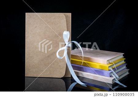 Best gift for men. Man gift concept. Various notebooks with craft gift box black background. Copy space text. Valentine's day, wedding, birthday and special occasion gift concept. Copy space for text. 110908035