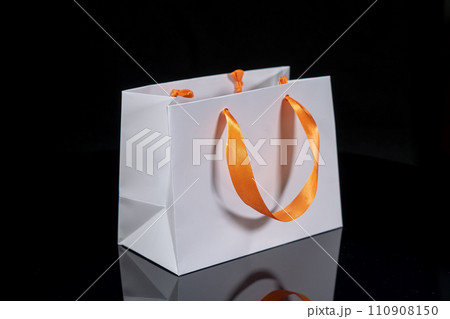 Recyclable craft paper bag for purchases, gifts and takeaway food mock up on black background. Environmentally friendly than single-use plastic bags Recyclable craft paper bag for purchases, gifts and takeaway food mock up on black background. Environmentally friendly than single-use plastic bags 110908150