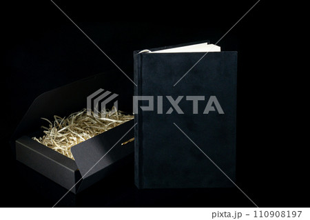 Best gift for men. Man gift concept. Black notebook with black gift box on black background. Copy space text. Valentine's day, wedding, birthday and special occasion gift concept. Copy space for text. 110908197