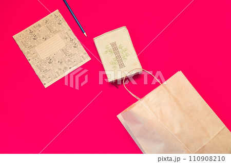 Top view brown paper shopping bag on colourful background, Mock-up of blank brown paper shopping bag and copy space. Flat lay. 110908210